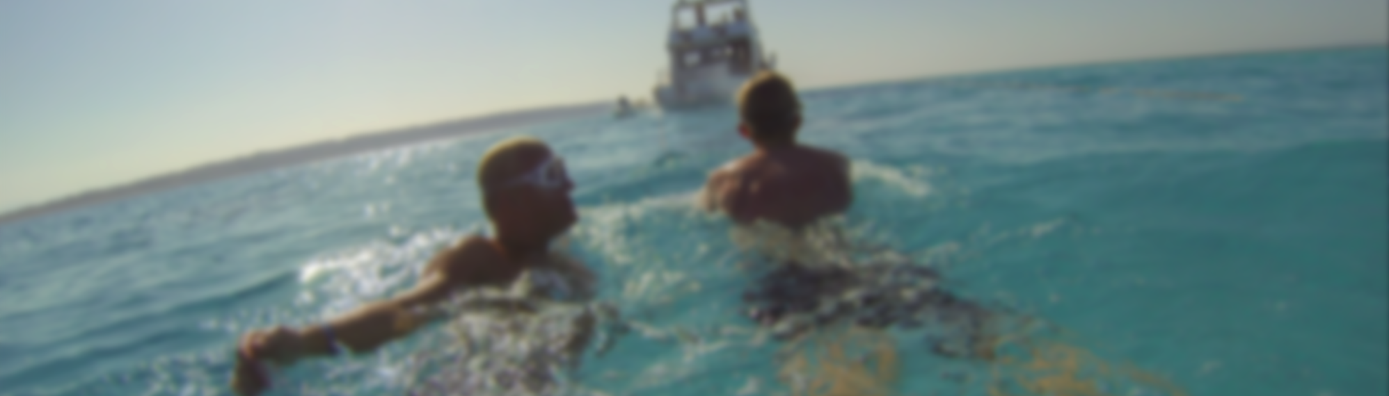 two people on the water surface with subwing blurry background