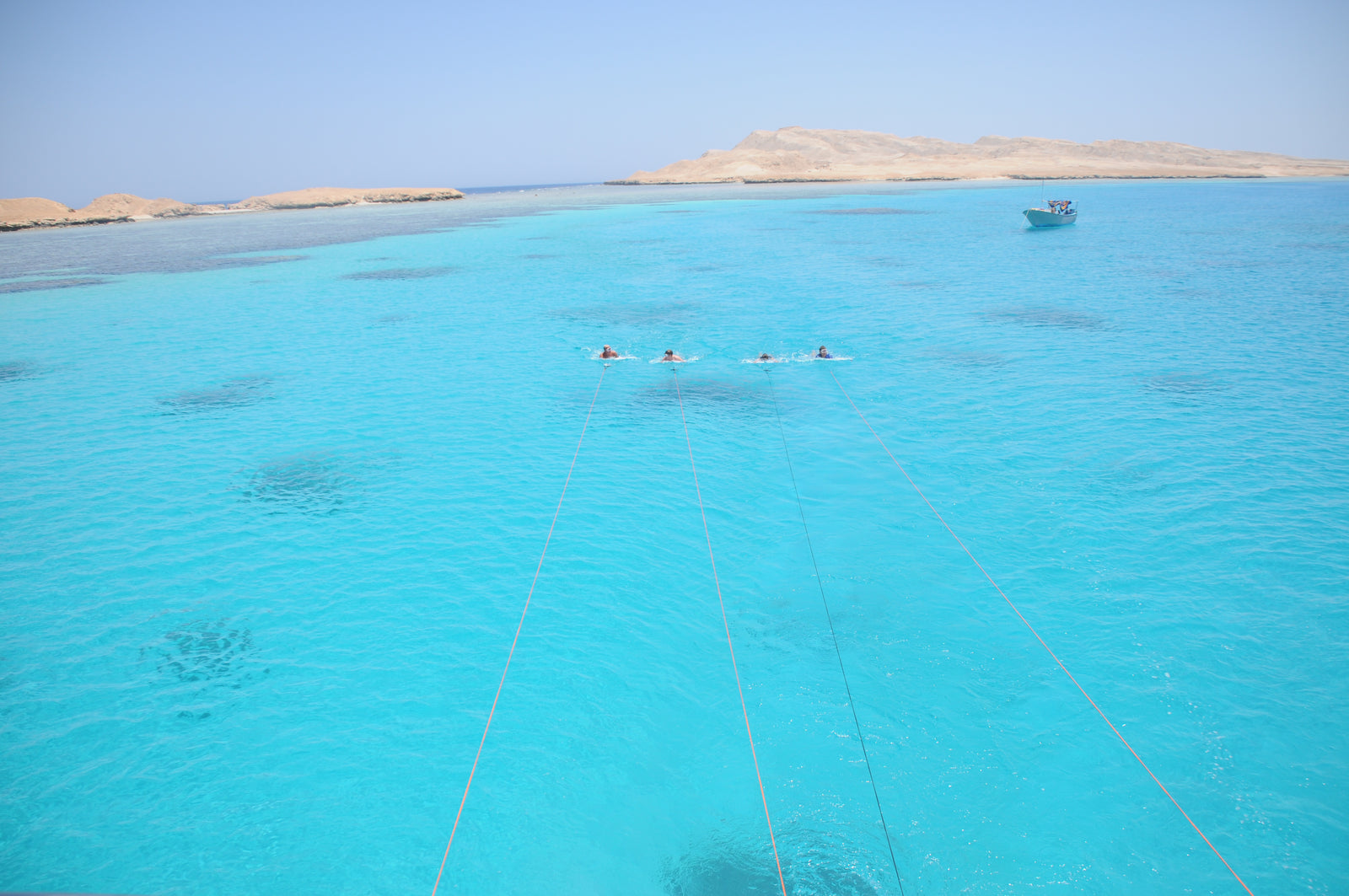 four subwing riders on surface towed by boat