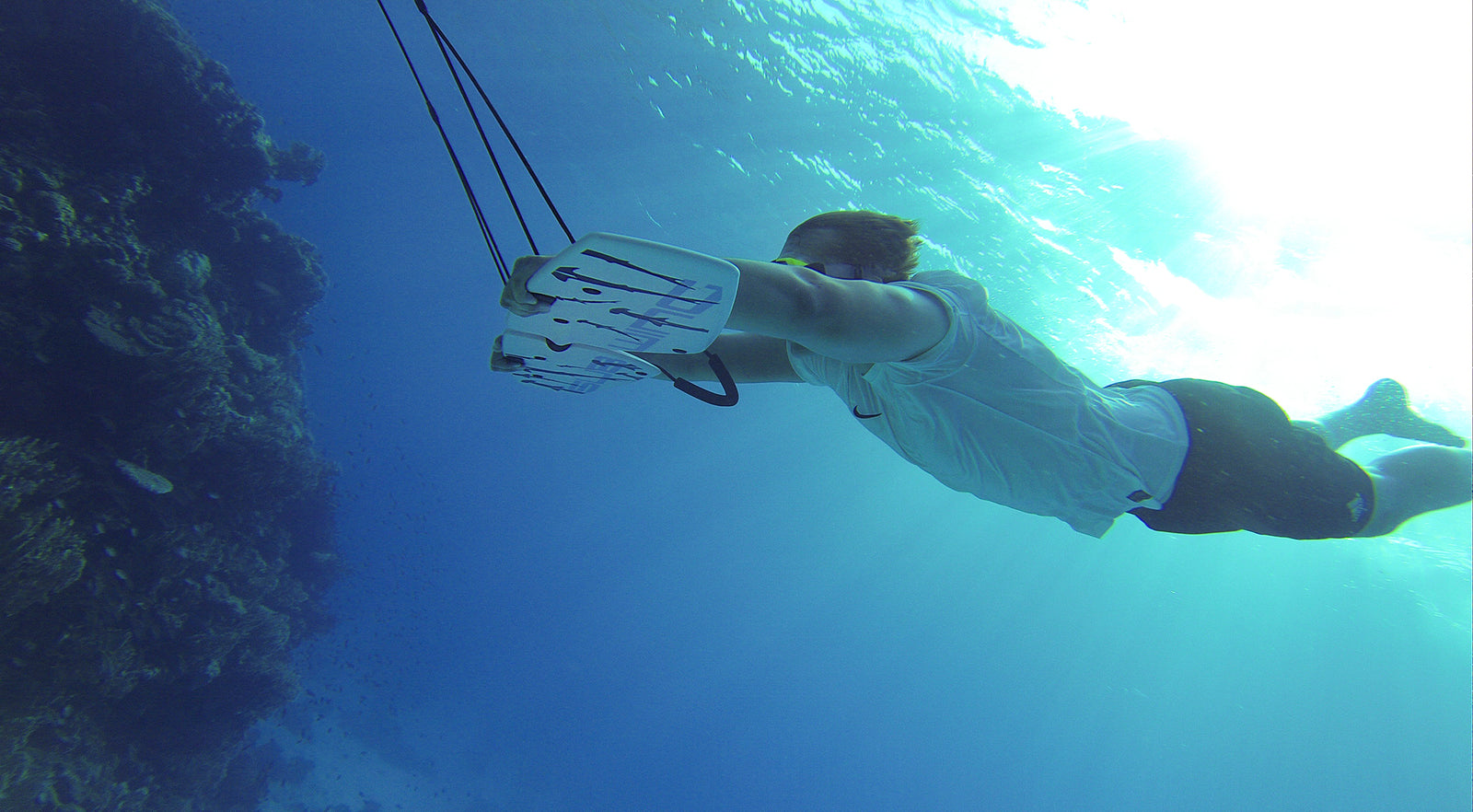 Subwing rider diving down underwater