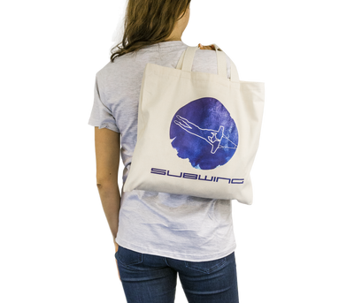 Woman holding cotton beach bag with Subwing logo