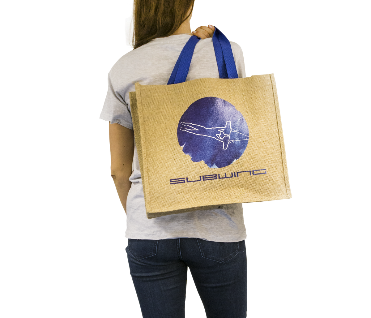 Woman holding jute beach bag with Subwing logo