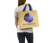 Woman holding jute beach bag with Subwing logo
